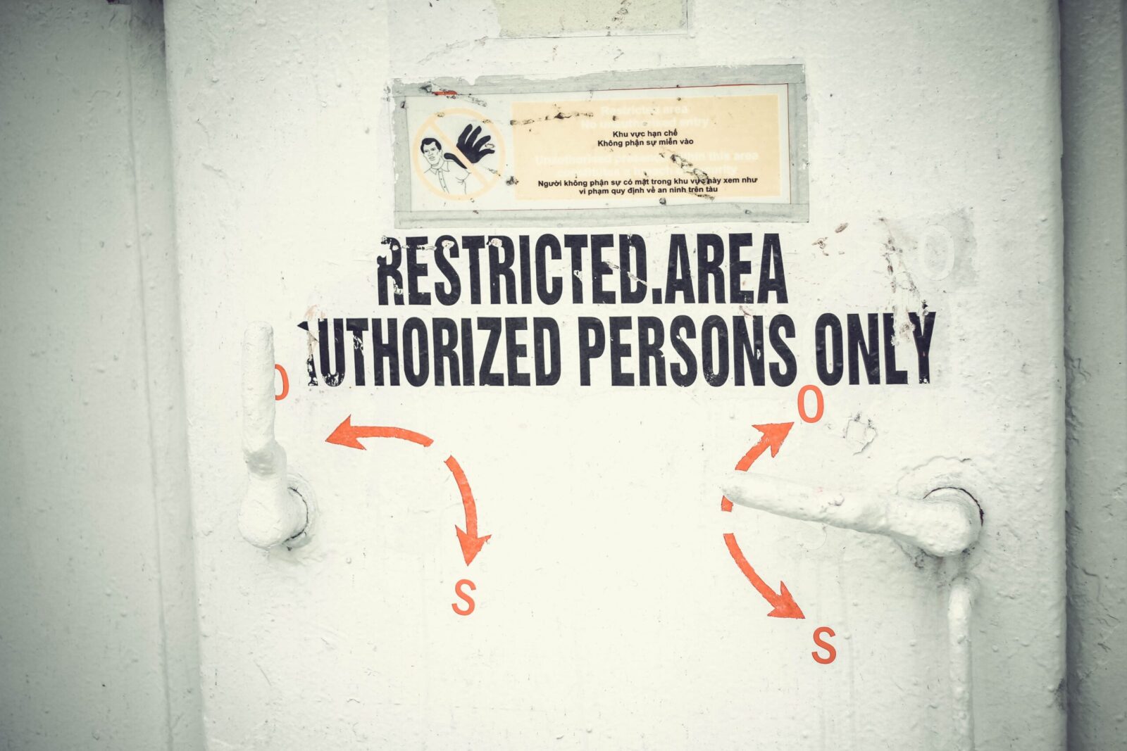 Close-up of a restricted area door with signage emphasizing authorized access only.