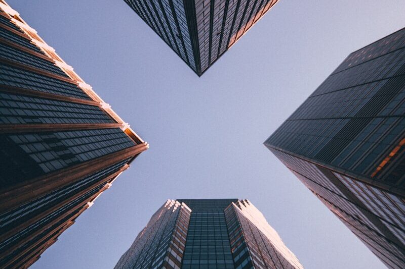 low-angle photography of four high-rise buildings